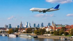 Air freight from China to Poland with cargo plane flying over Polish city skyline