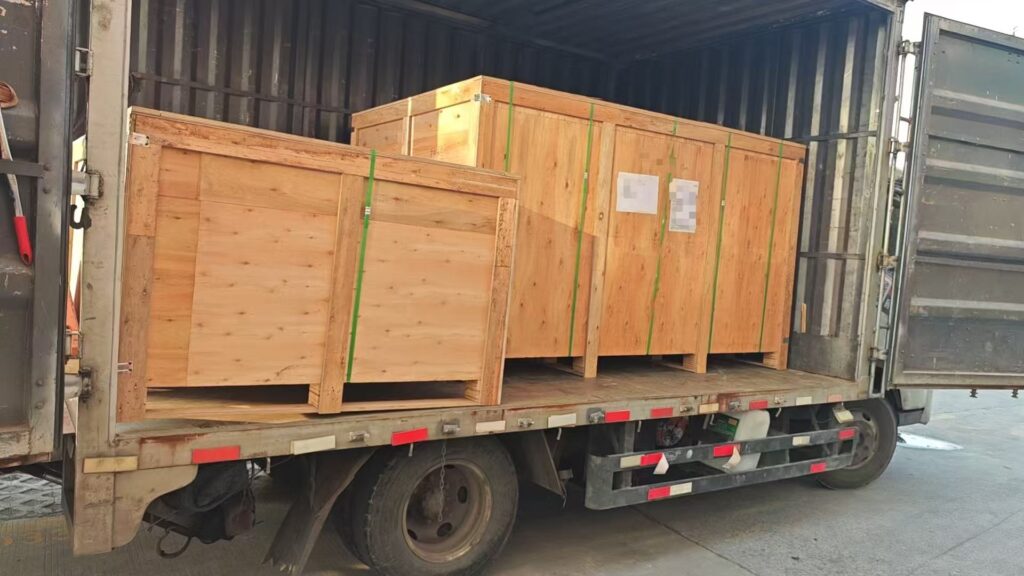 Wooden cases containing aluminum railings and cabinetry loaded onto a truck in Shenzhen