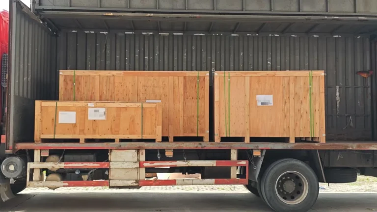 Three wooden cases containing aluminum windows and quartz stone countertops prepared for sea freight from Shenzhen to Miami